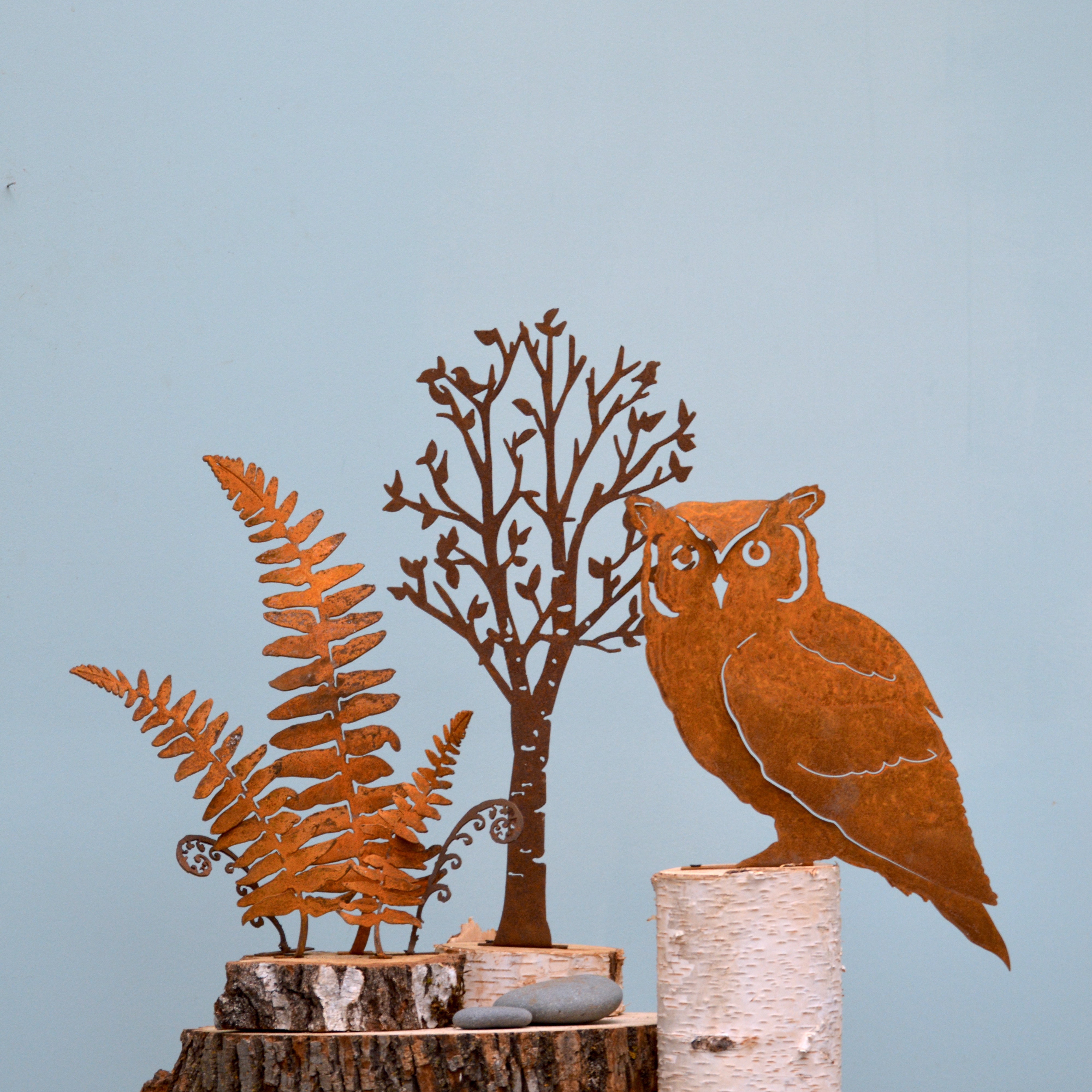 An owl and trees designed from metal